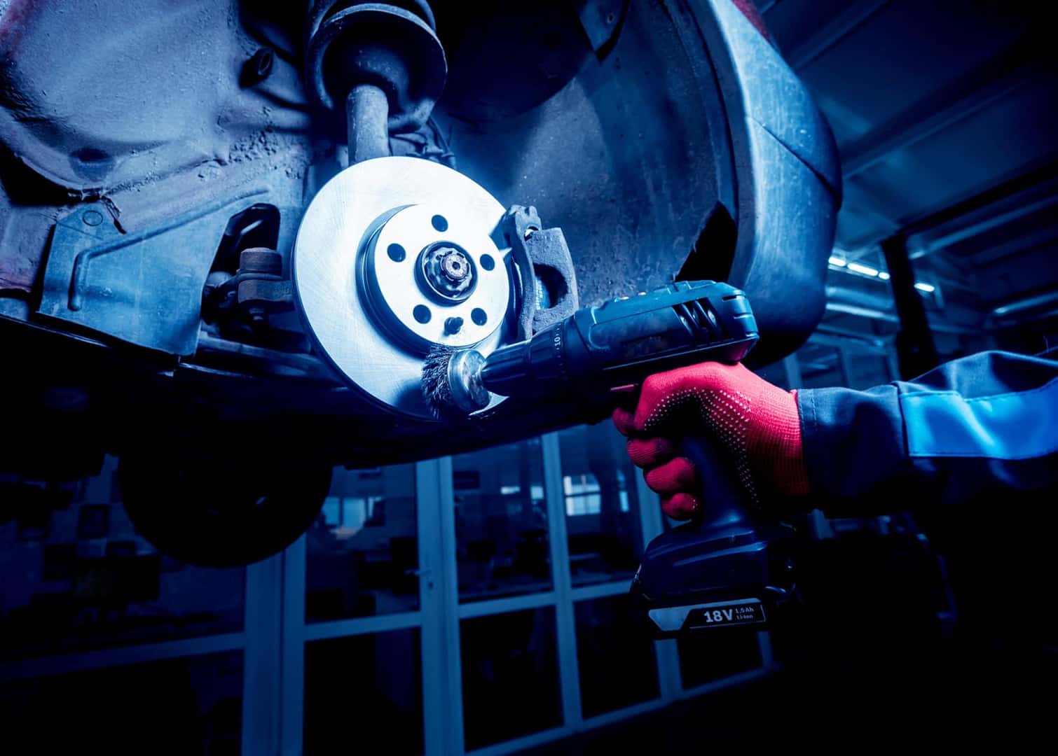 Technician using tool on brakes