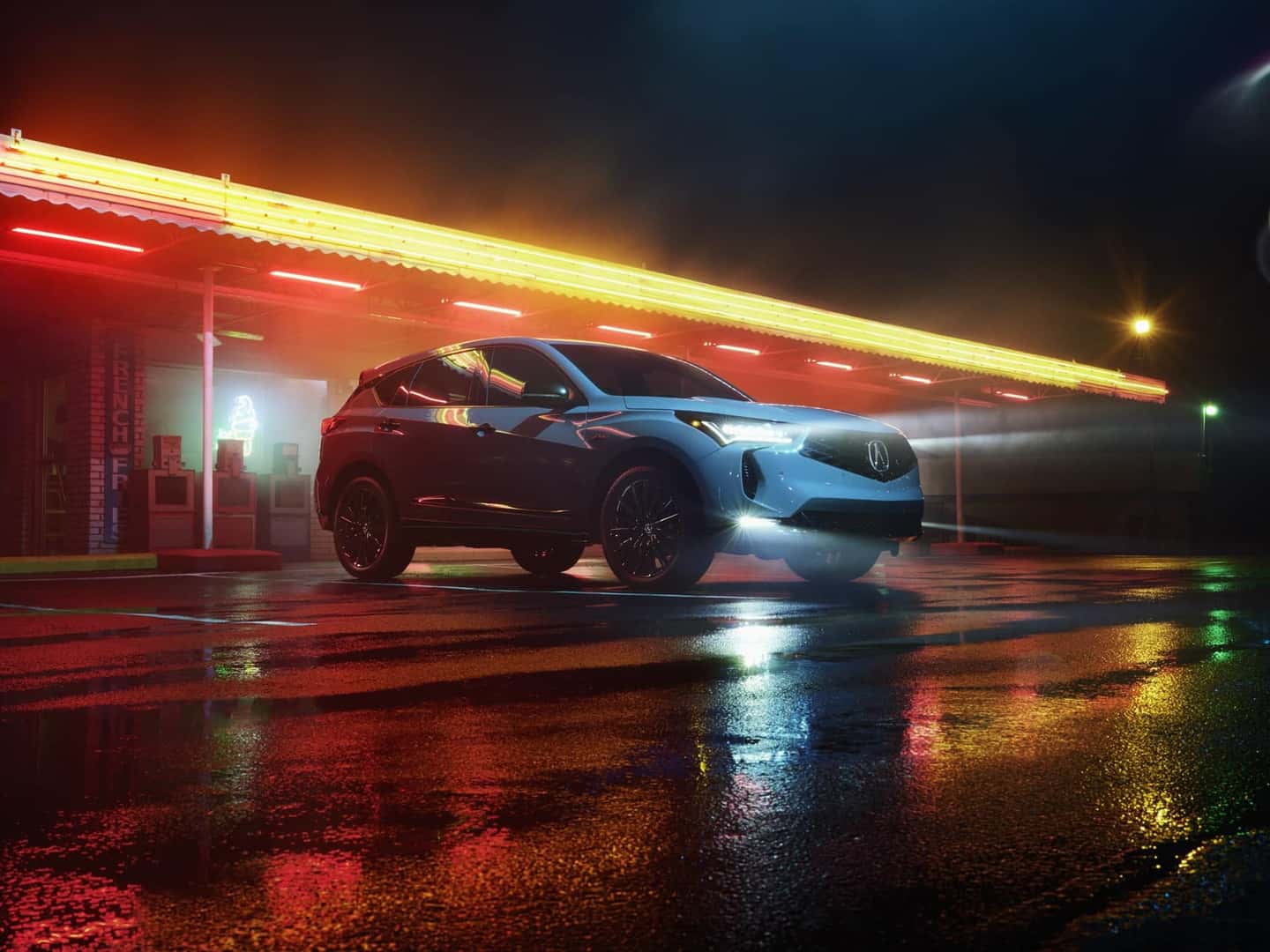 2025 Acura RDX with illuminated lights against a dark background
