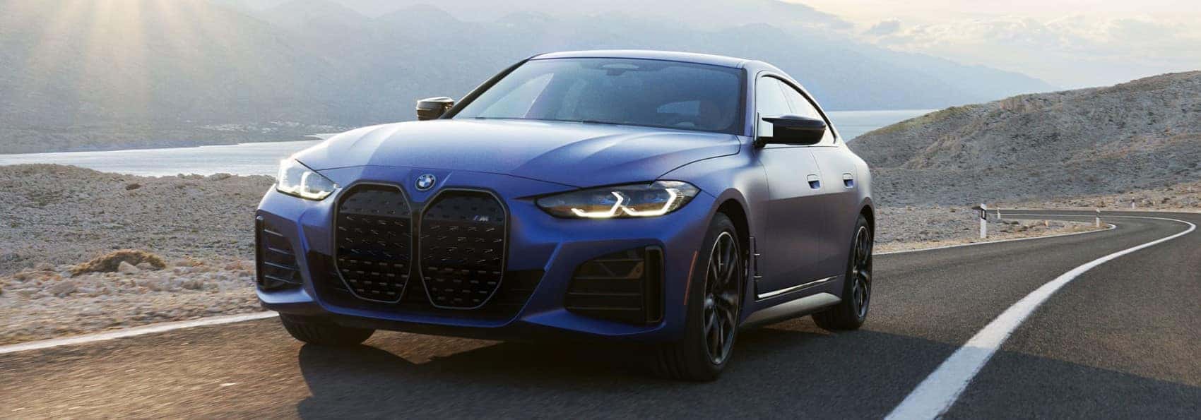 2022 BMW i4 blue driving on scenic highway