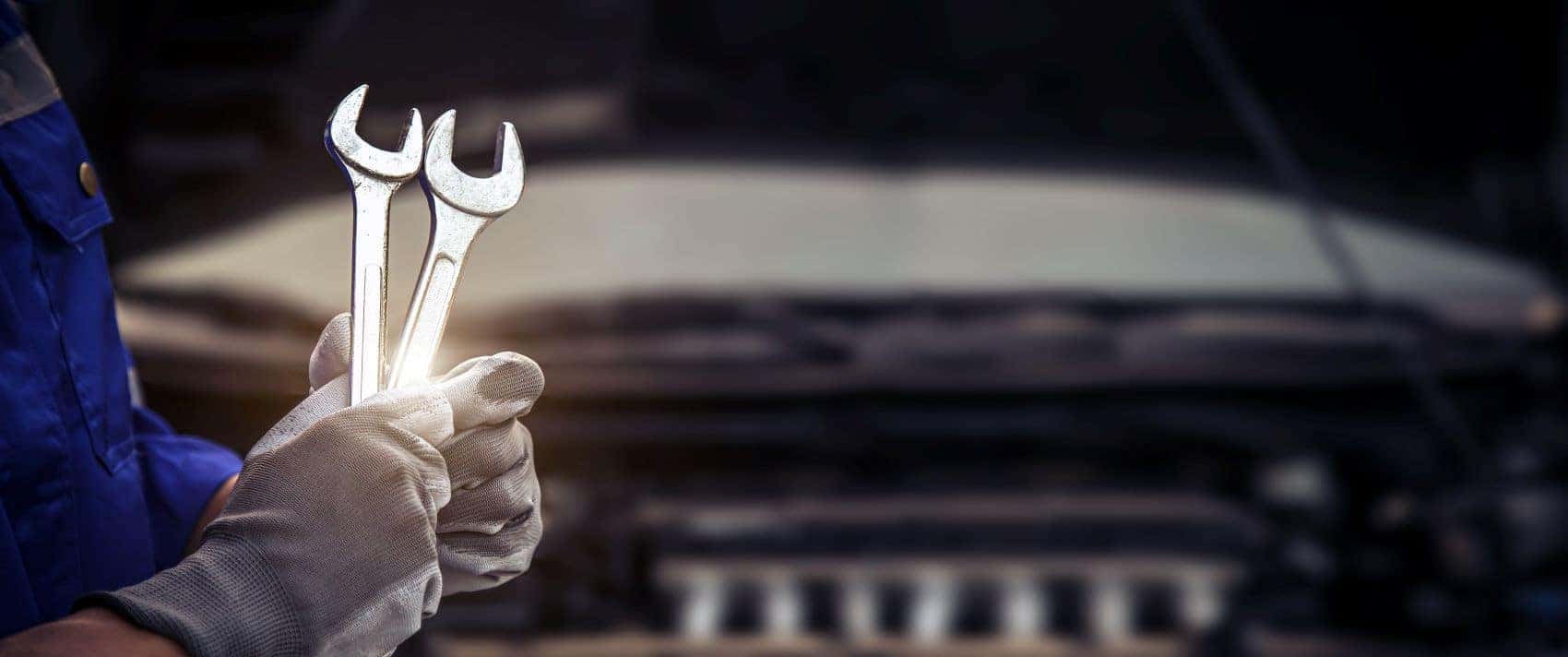 Mechanic holding wrenches