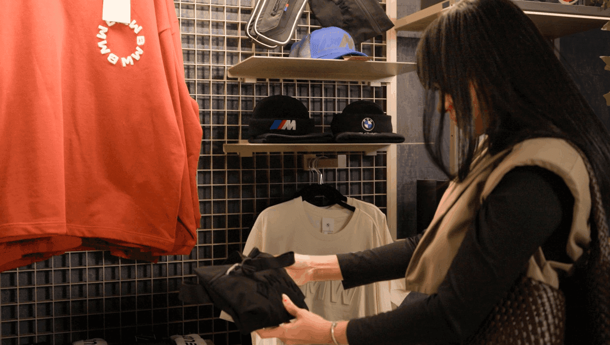 Shopper looking at bag in boutique