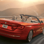 Red BMW on a winding road