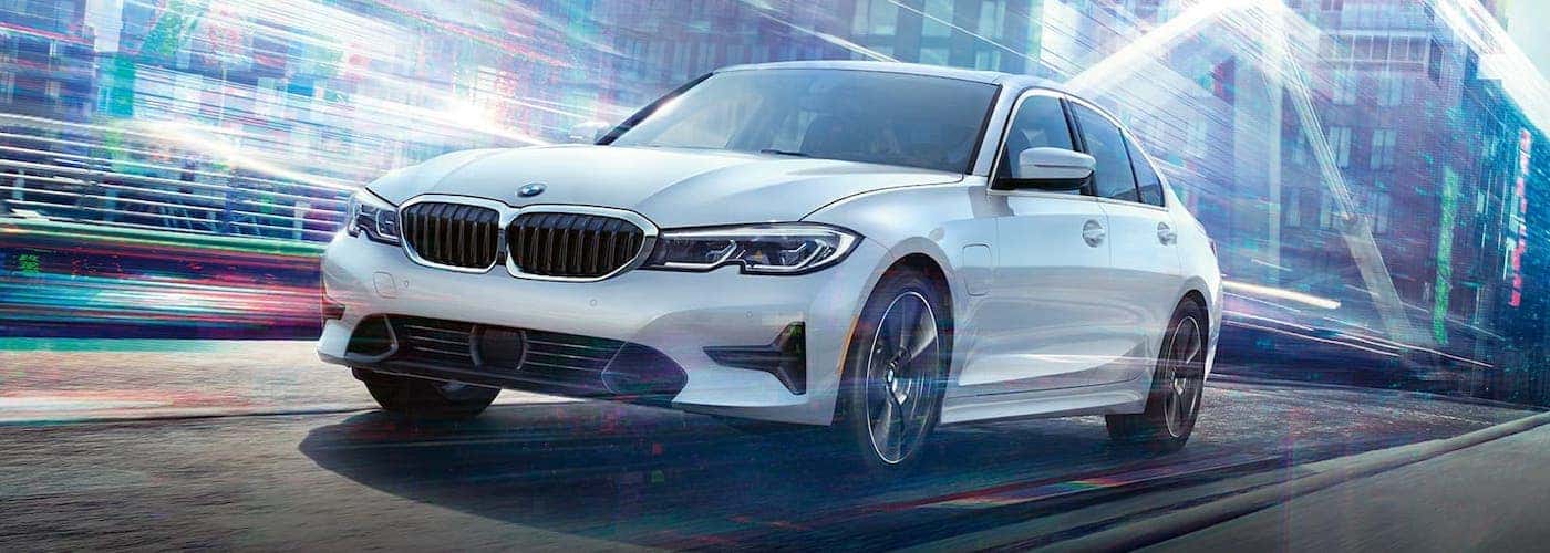 2020 bmw 3 series white exterior driving down road abstract lighting