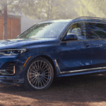 2020 bmw x7 blue exterior parked outside in wooded area