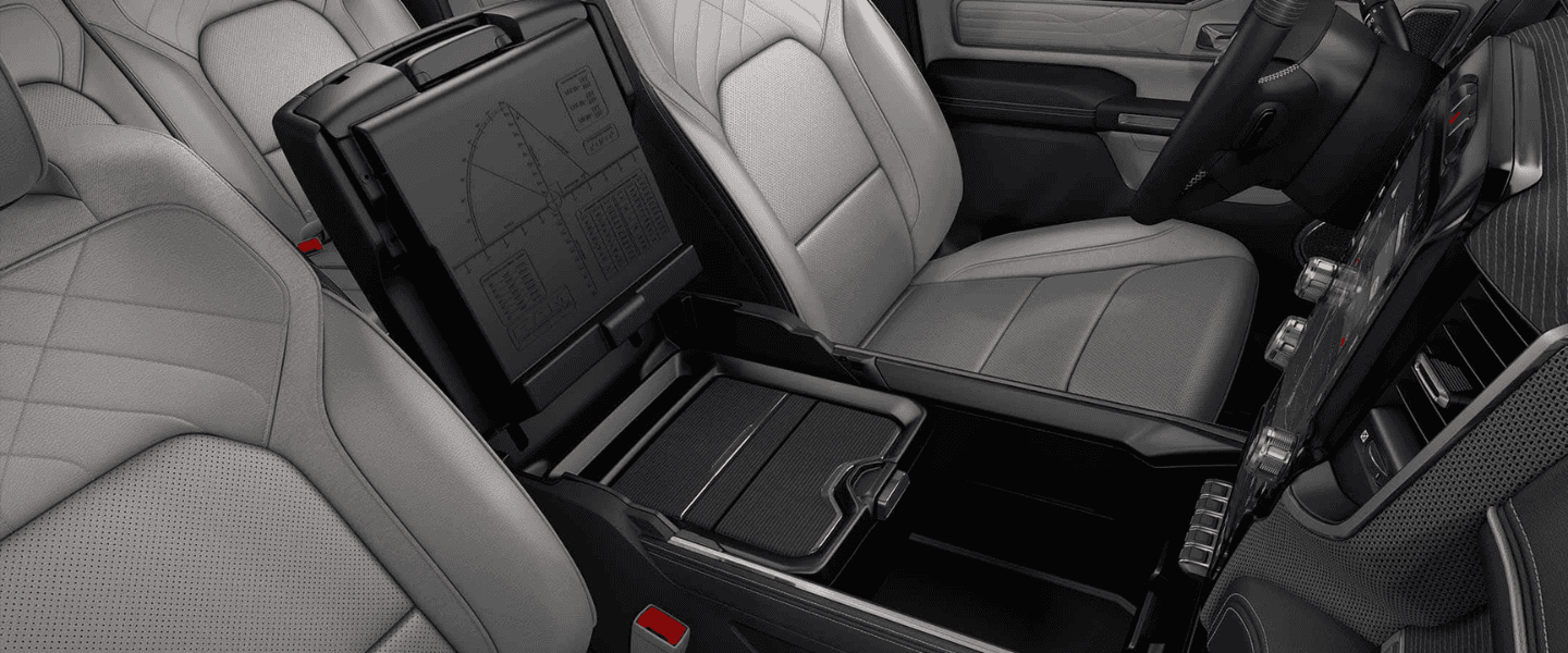 Ram 1500 interior with leather seats, storage compartment, and large touchscreen