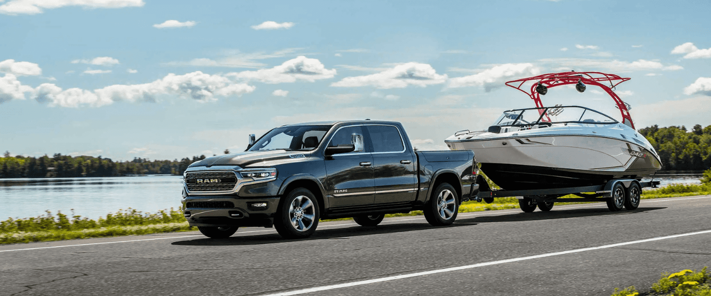 Gray Ram 1500 towing a boat