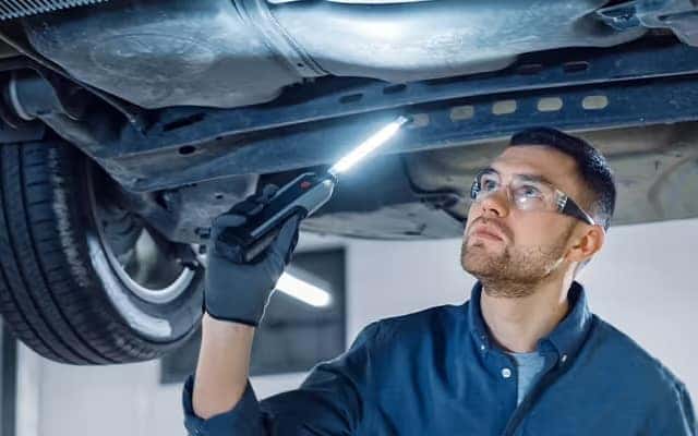 technician fixing car