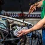 mechanic in waukesha wi checking the oil levels in a vehicle