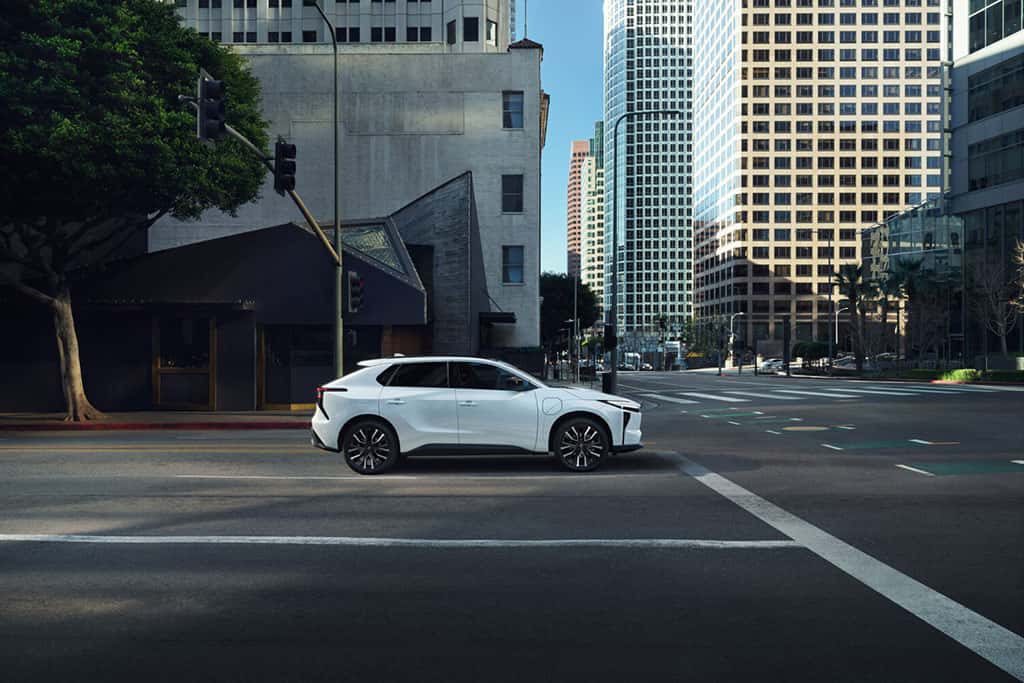 2026 Toyota bZ parked in white at a stoplight in an urban area