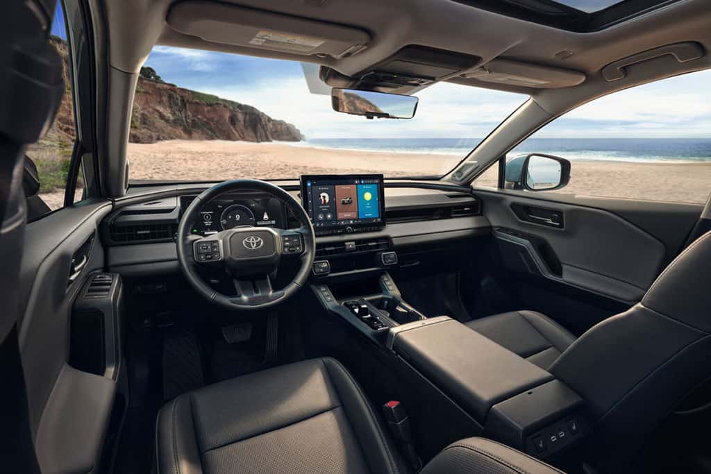 2026 Toyota RAV4 Limited parked at a beach showing interior and infotainment technology