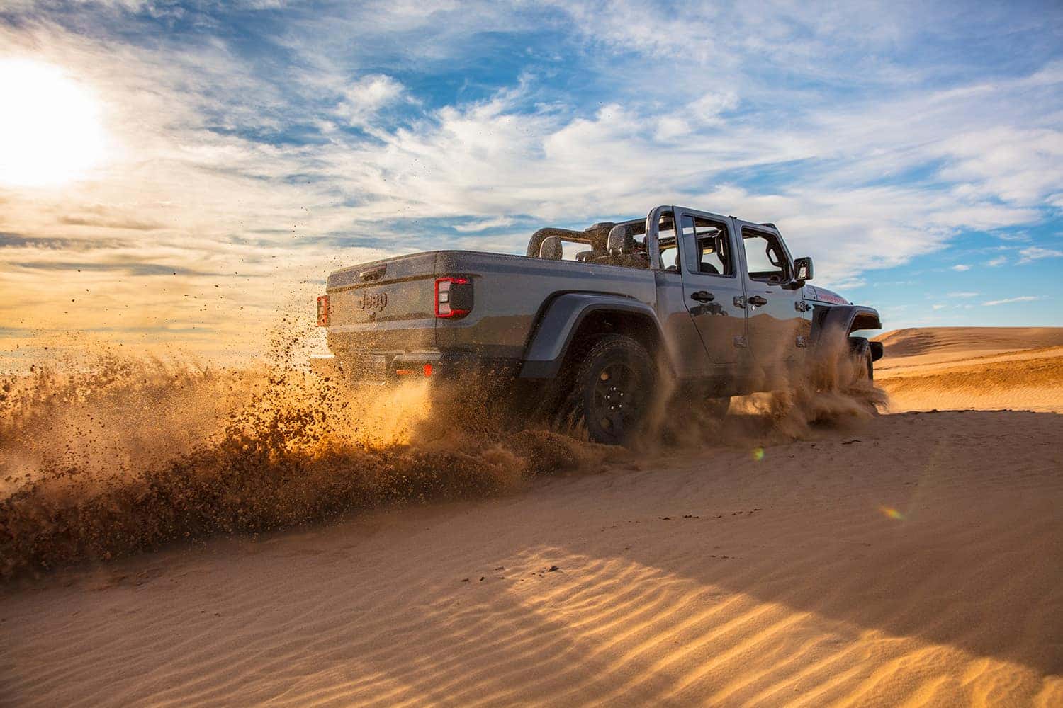 Compare the 2021 Jeep Gladiator vs. the 2021 Toyota Tacoma at Carolina Chrysler, Dodge, Jeep, and Ram | 2021 Jeep Gladiator driving off road