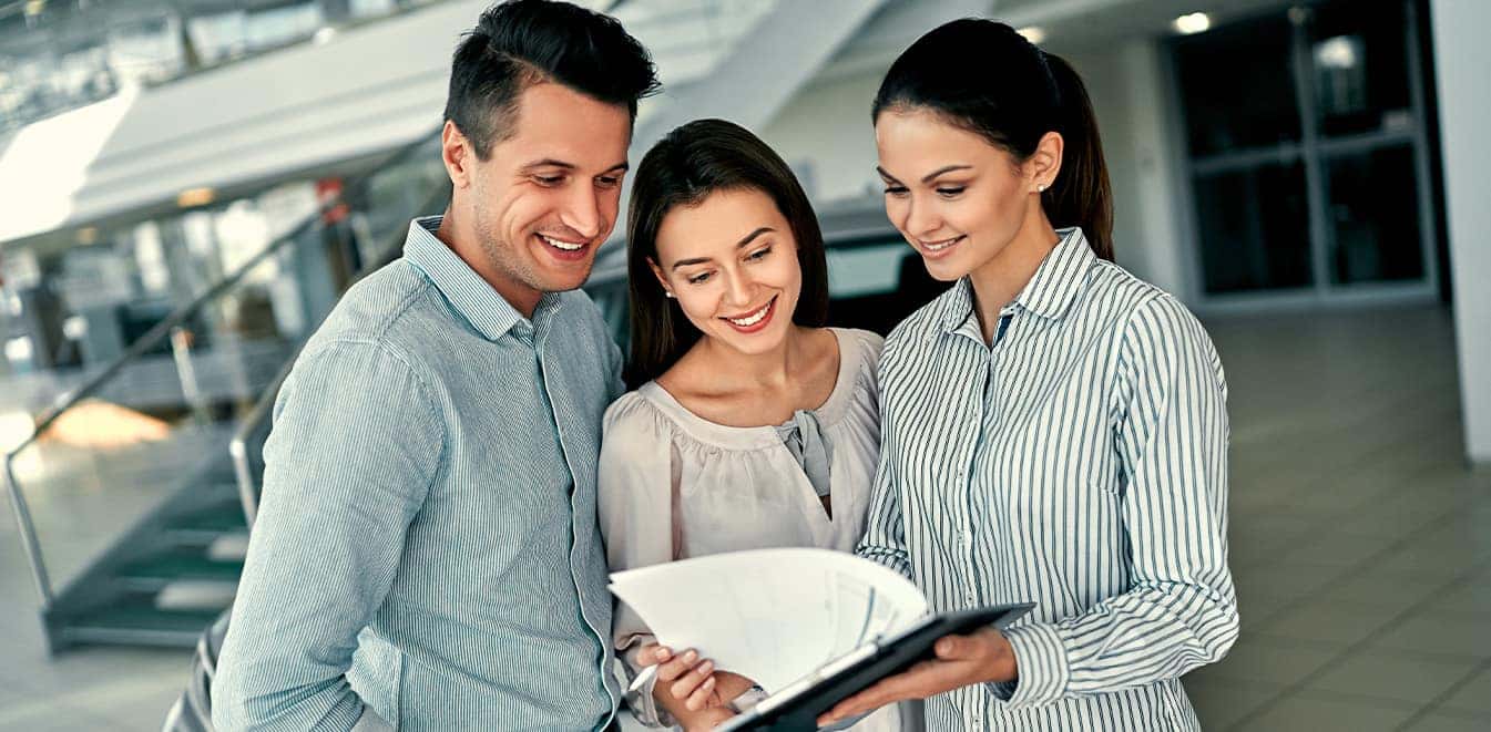 Defining GAP Insurance at Carolina Chrysler Dodge Jeep & RAM in Elizabeth City, NC | Sales Advisor Talking to Customers On Sales Floor