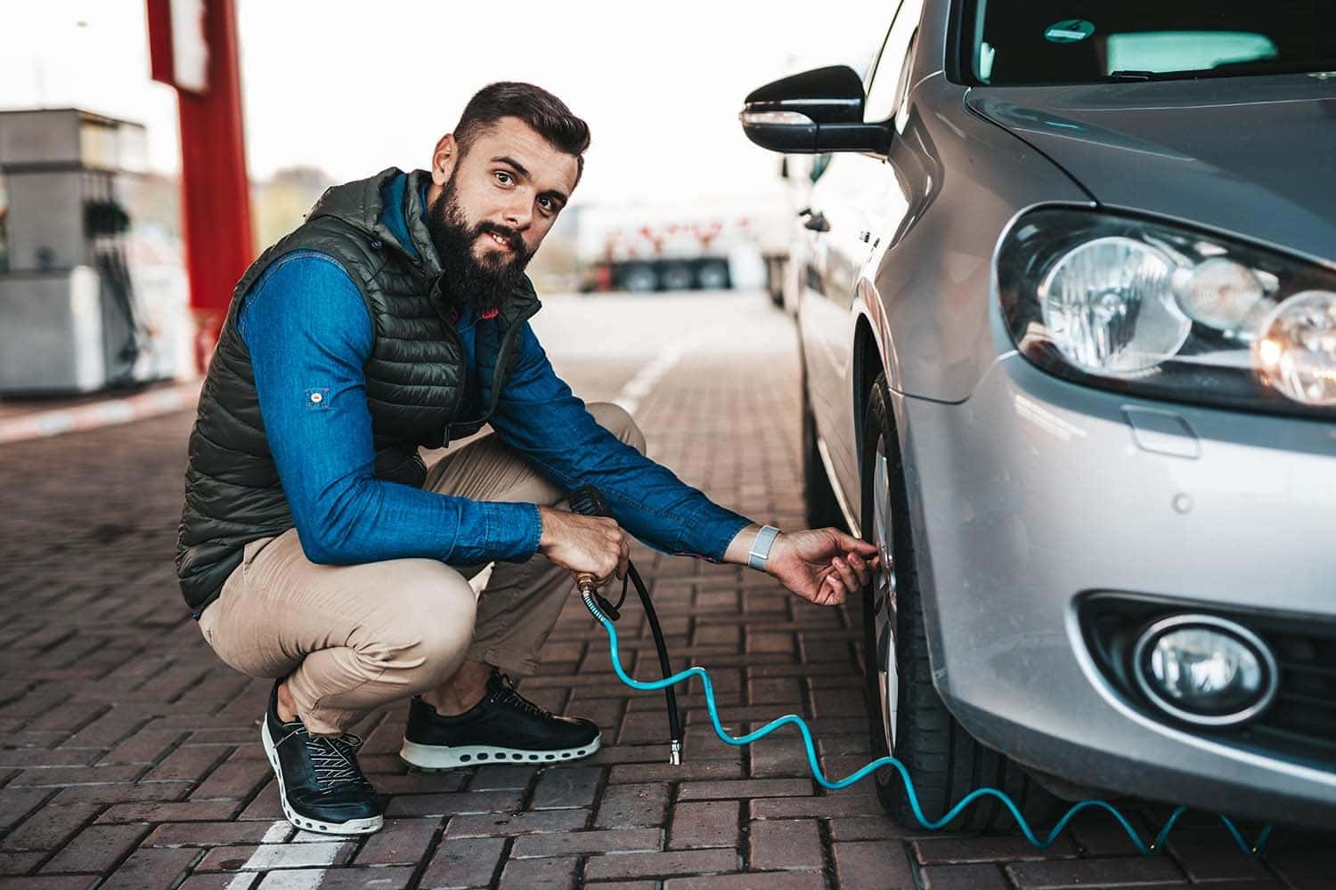 How to check your tires' health at Carolina Chrysler Dodge Jeep & Ram | Man putting air in his tires