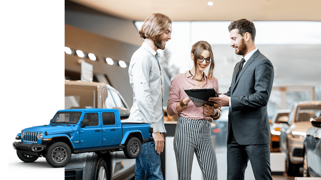 Best Time To Buy At Carolina CDJR in Elizabeth City, NC | 2023 Jeep Gladiator in the color blue with a background photo of sales person in suit with a clipboard talking to the couple on the left side