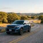 2026 Jeep Grand Cherokee front view on a winding road in Austin Texas Hill Country