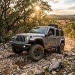 2027 Jeep Wrangler concept navigating a rugged limestone trail in the Austin Texas Hill Country