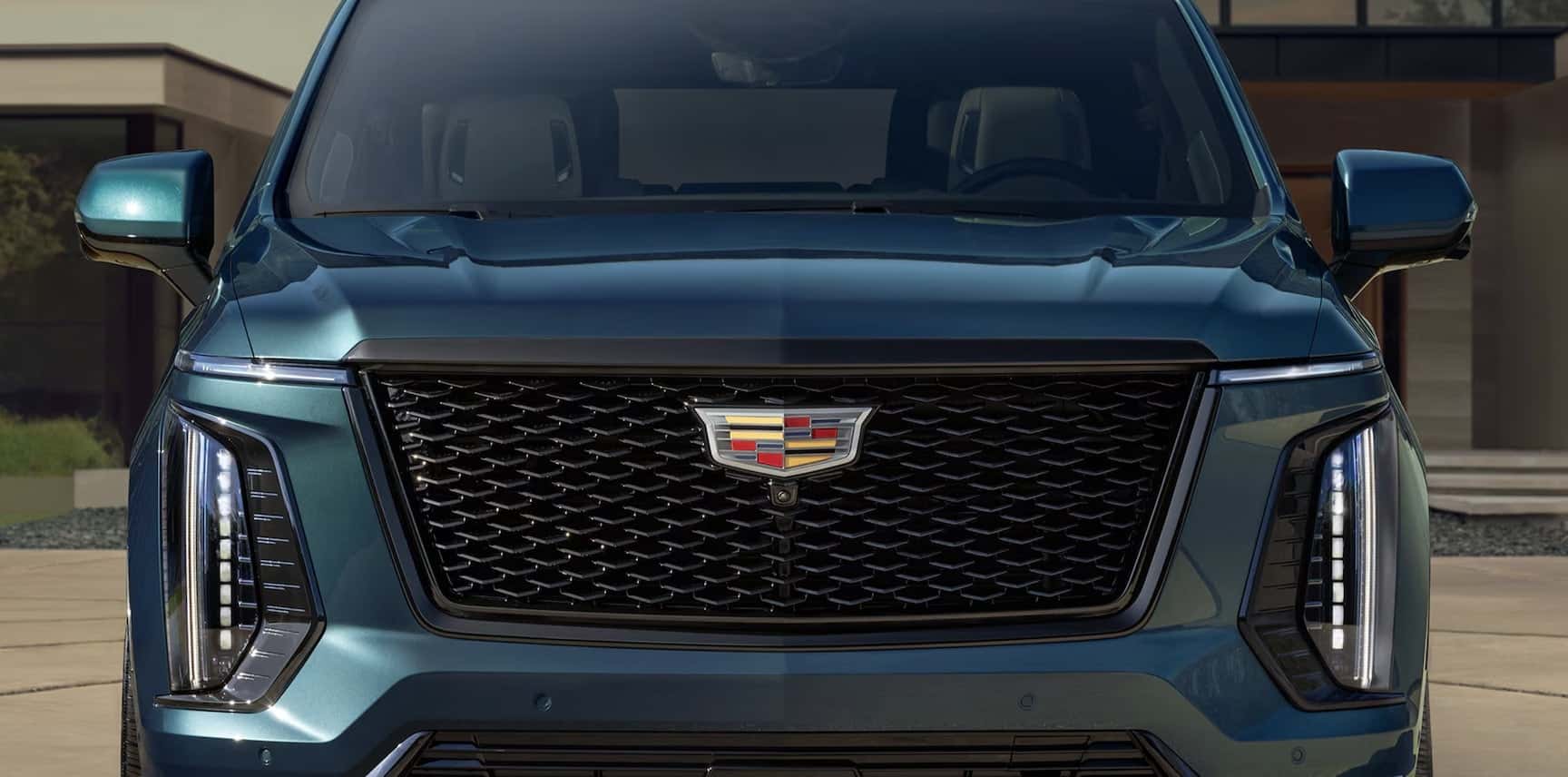 Cadillac Escalade bold front view of suv in Austin tx driveway