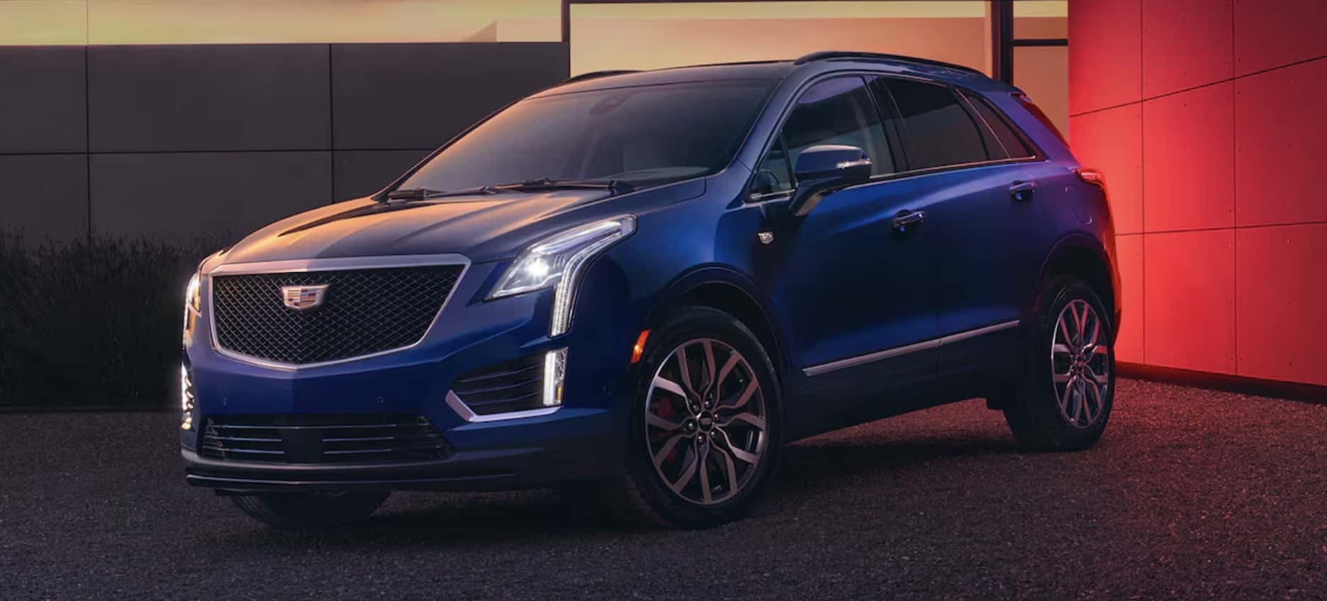 Side view of blue Cadillac XT5 in driveway on Austin tx streets