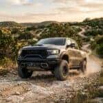 New 2026 RAM 1500 RHO in a wide-body stance on a winding trail in the Austin Texas Hill Country