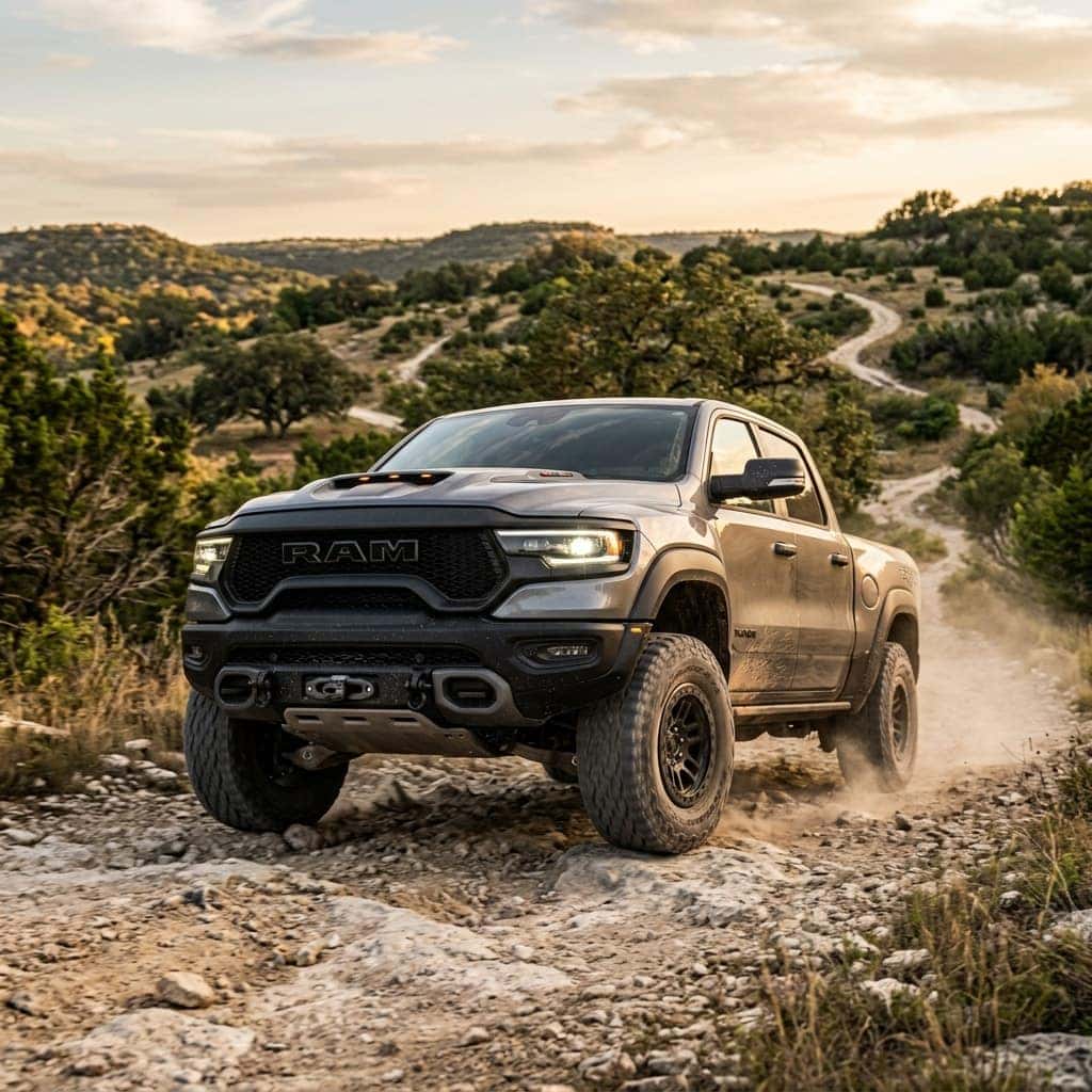 New 2026 RAM 1500 RHO in a wide-body stance on a winding trail in the Austin Texas Hill Country