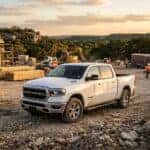 white used Ram 1500 Big Horn work truck parked on a rugged construction site in austin texas