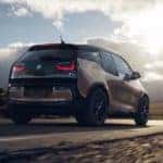 2020 bmw i3 driving on road rear side view