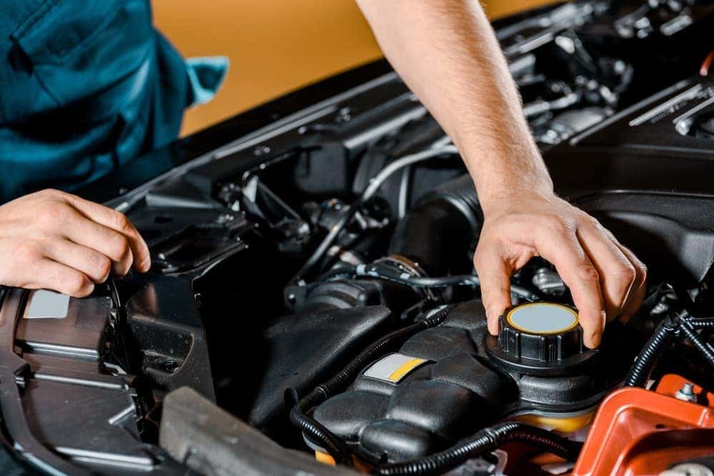 2019 auto-mechanic-checking-under-car-hood