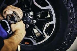 Mopar Technician mounting a rim and tire to a vehicle