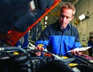 Mopar technician checking fluids in vehicle