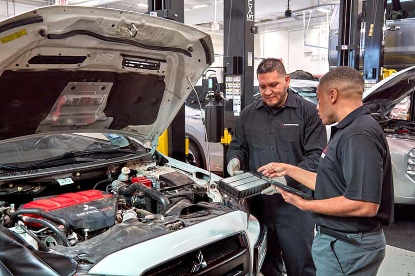 Mitsubishi Technician showing service advisor an air filter