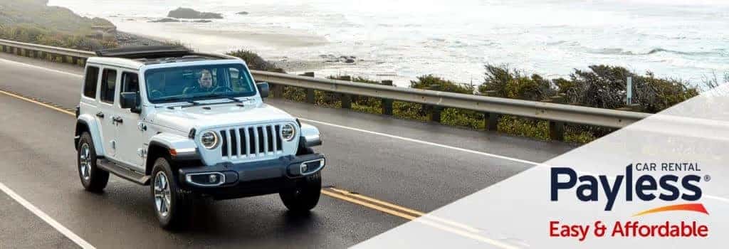 Payless Rental Jeep Wrangler driving on the road
