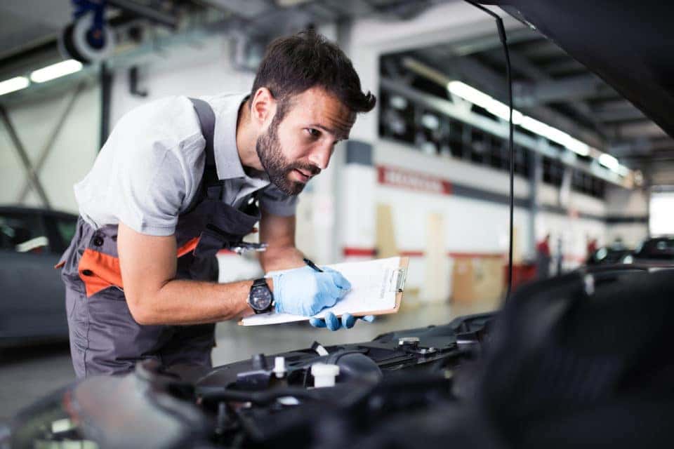 Car mechanic performing an inspection