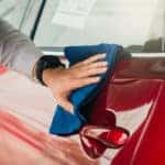 man cleaning car