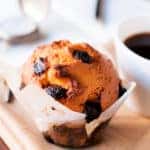 Blueberry muffin with coffee in a white mug