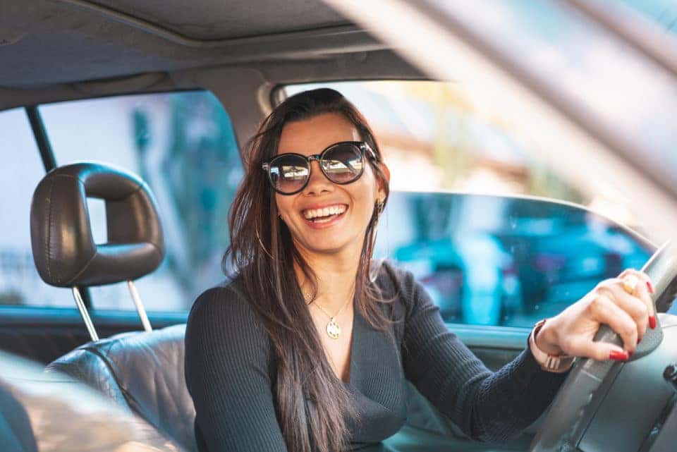 Woman driving with sunglasses on