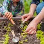 Child and mother gardening