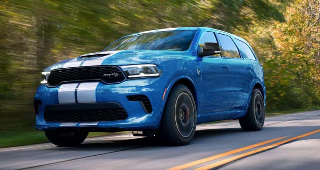 Blue Dodge Durango driving on road