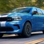 Blue Dodge Durango driving on road