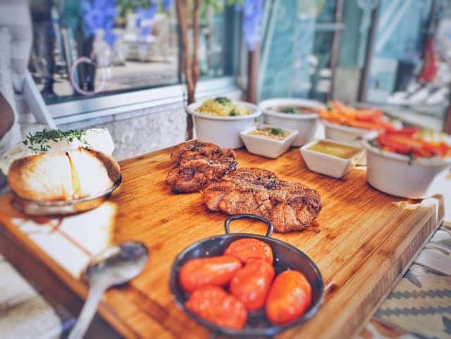 Grilled meat on brown wooden tray