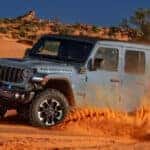 Gray Jeep Wrangler driving in the sand