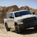 tan Ram 1500 driving in the sand