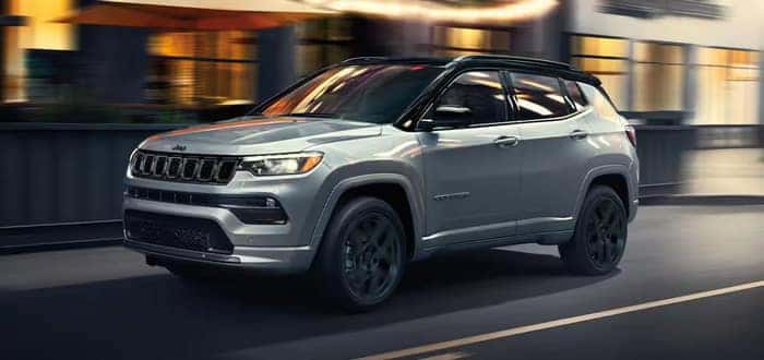 Silver Jeep Compass driving on the road