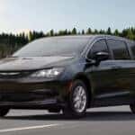 Black Chrysler Voyager driving on road