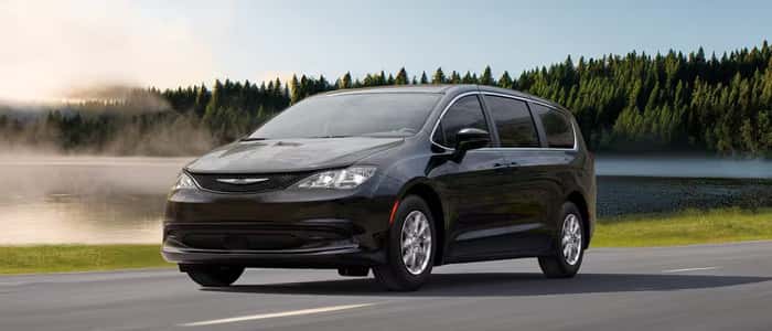 Black Chrysler Voyager driving on road