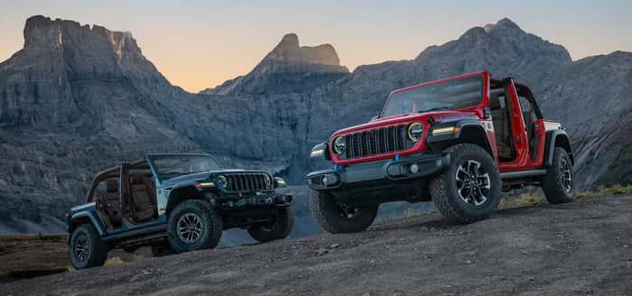 2 Jeep Wranglers parked on the rocks