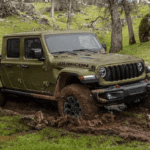 Green 2025 Jeep Gladiator Rubicon driving in mud