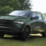 Green 2026 Ram 1500 Rebel towing a vehicle