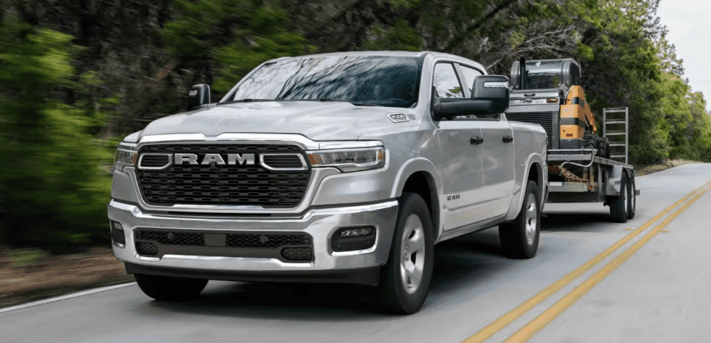 Silver 2026 Ram 1500 towing a trailer