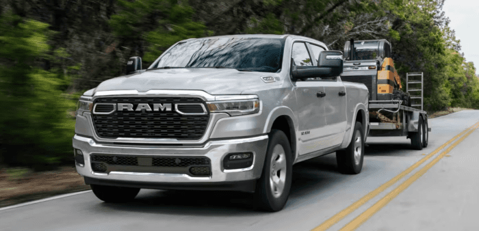 Silver 2026 Ram 1500 towing a trailer