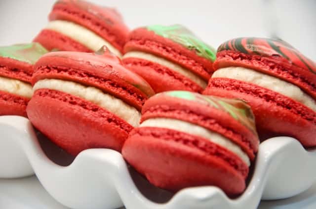 A close up plate of red and white macaroons